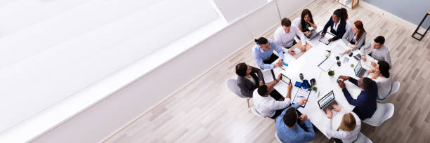Multi Ethnic Business People Having Business Meeting Group Of Multi Ethnic Business Team Sitting Together At Workplace In Modern Office employee engagement stock pictures, royalty-free photos & images