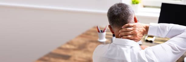 istock Businessman Suffering From Neck Pain 1390560403