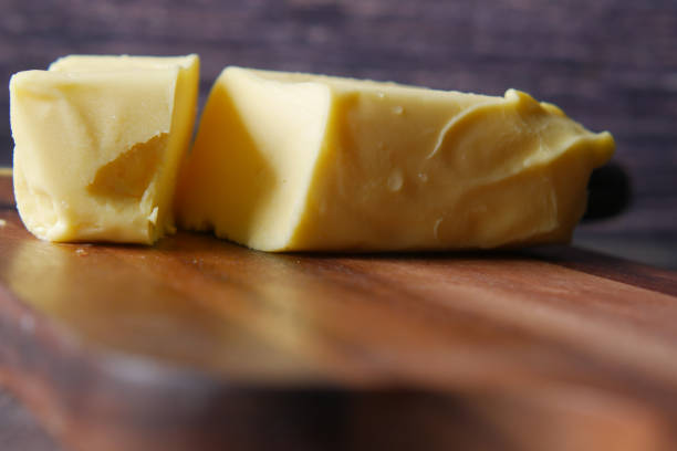 istock slice of a butter on a paper on table 1390567524