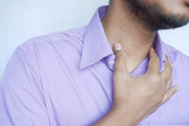 istock unrecognized man suffering throat pain close up 1390568365