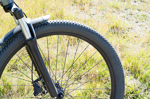 Close up of electric mountain bike front wheel in alpine meadow