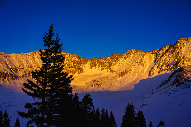 Sunset Alpenglow Rugged Tenmile Range Peaks Sunset Alpenglow Rugged Tenmile Range Peaks - Warm alpenglow on high mountain peaks scenic landscape winter view. tenmile range stock pictures, royalty-free photos & images