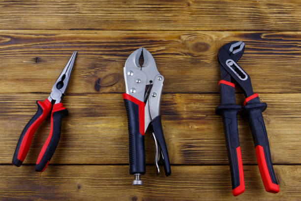 istock Set of different pliers on wooden background. Top view 1390583396