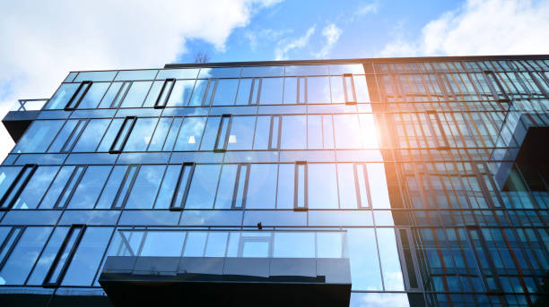 istock Modern office building with glass facade on a clear sky background. 1390583672