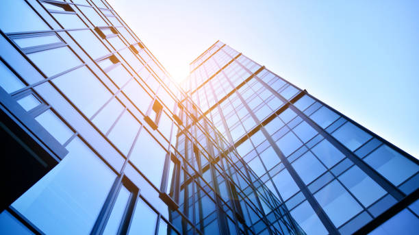 istock Modern office building with glass facade on a clear sky background. 1390583715