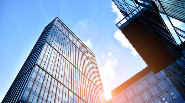 istock Modern office building with glass facade on a clear sky background. 1390583726
