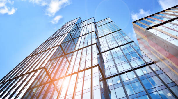istock Modern office building with glass facade on a clear sky background. 1390583746