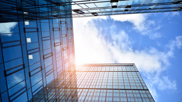 istock Modern office building with glass facade on a clear sky background. 1390583759