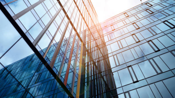 istock Modern office building with glass facade on a clear sky background. 1390584278
