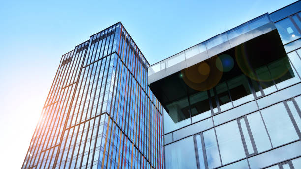 istock Modern office building with glass facade on a clear sky background. 1390584304