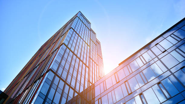 istock Modern office building with glass facade on a clear sky background. 1390584313