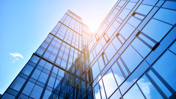 istock Modern office building with glass facade on a clear sky background. 1390584364
