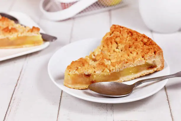 Slice of traditional German apple pie with topping crumbles called 'Streusel'