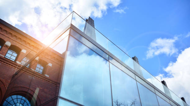 istock Modern office building with glass facade on a clear sky background. 1390584507