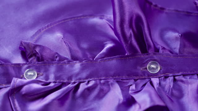 Purple ruffles close-up. Sewing a violet dress. Handmade tailoring, professional clothing concept. Abstract background