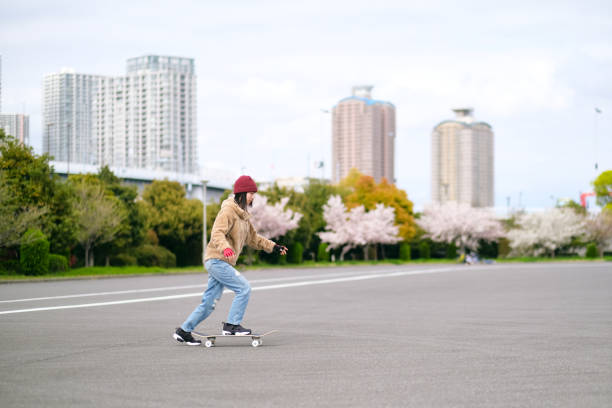 istock Young woman riding on skateboard 1390590306