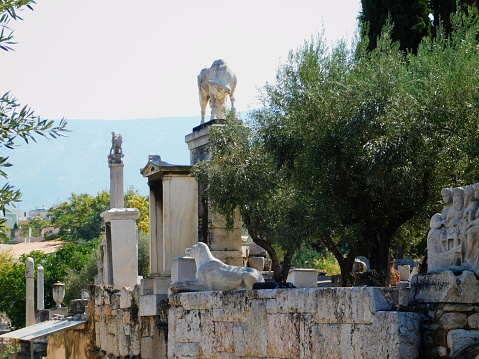 September 2018, Athens, Greece. Ancient ruins in the cemetery of Keramikos. Old grave memorials, columns, statues