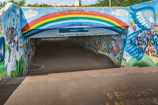 Mykolaiv, Ukraine - July 26, 2020: Underpass on the Heroiv Stalinhradu Avenue near Peremohy Park in Mykolaiv. Ukrainian traditional art and vandal graffiti on the walls of the tunnel