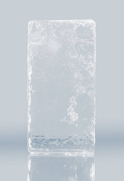 istock Crystal clear frosty textured natural ice block on plain background on mirroring surface. 1390602702