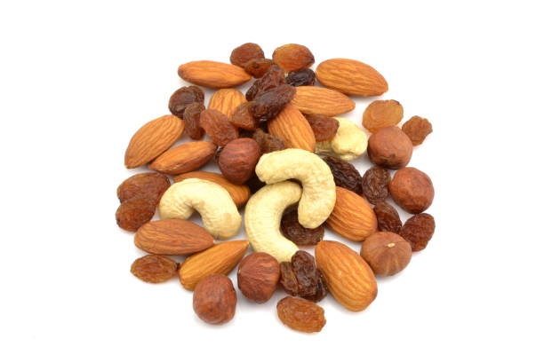 Healthy eating: assorted nuts and seeds portion in a glass bowl and notepad on white background