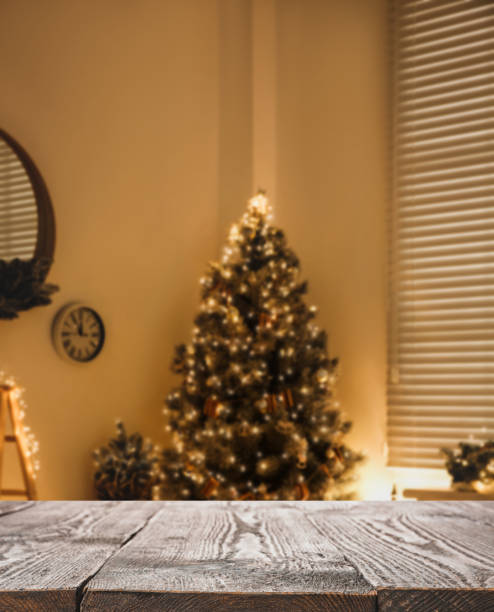 istock Empty wooden surface and blurred Christmas tree in room on background, bokeh effect. Space for design 1390606038