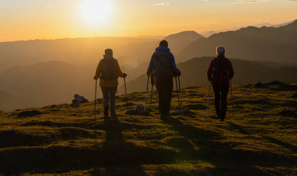 istock Silhouettes Of Hikers At Sunset 1390606066