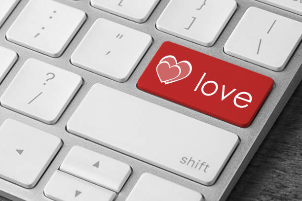 istock Love button on laptop keyboard, closeup. Online dating site 1390606071