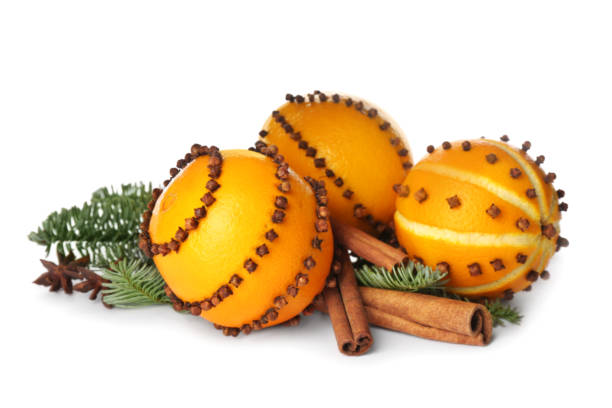 Pomander balls made of fresh oranges and fir tree with spices on white background Pomander balls made of fresh oranges and fir tree with spices on white background scent container stock pictures, royalty-free photos & images