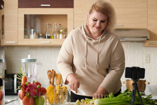 istock Woman Filming Smoothie Recipe Video 1390609531