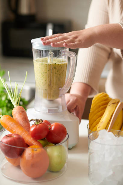 istock Woman Making Delicious Smoothie 1390609545