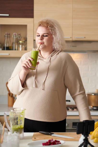 istock Woman Sipping Green Smoothie 1390609548