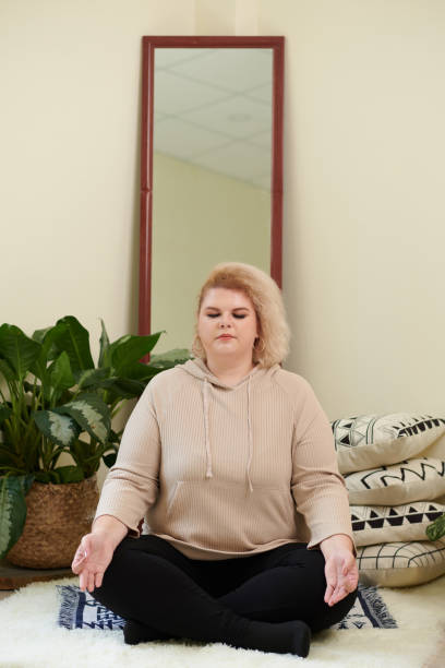istock Calm Woman Meditating at Home 1390609563