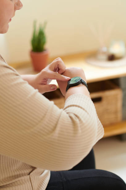 istock Woman Checking Fitness Tracker 1390609572