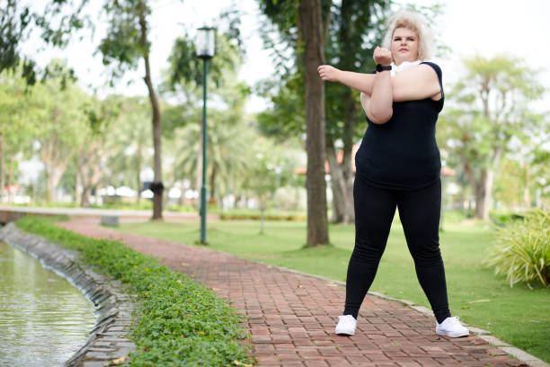 istock Curvy Woman Warming up in Park 1390609577