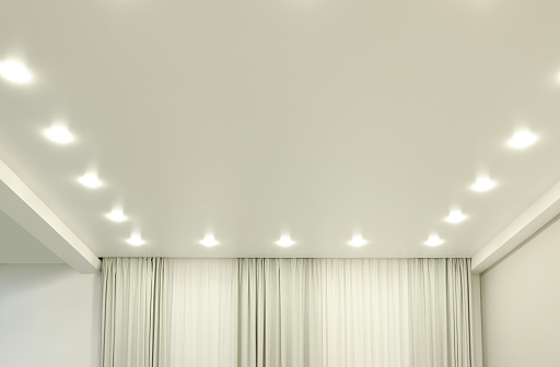 White stretch ceiling with spot lights in room