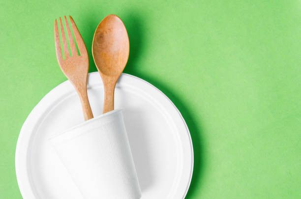 istock Eco friendly biodegradable paper disposable for packaging food on green background. 1390614065