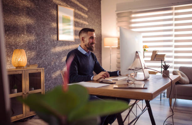 istock Happy businessman working on a computer in the office 1390614777