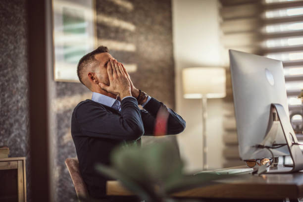 istock young businessman experiencing stress during at work 1390616534