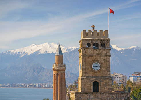 Old Town Antalya with the Clock Tower and  Yivli Minaret (Fluted Minaret) Mediterranean Sea and Taurus Mountains on background