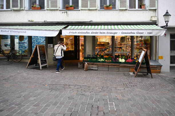 Radolfzell, Germany, March 30, 2022 - Grocery Store in Radolfzell on Lake Constance, an unidentified lady in the background
