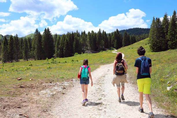istock mom with three children walking on the mountain trail 1390625831