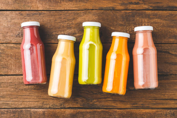 istock Fresh fruit and vegetable smoothies in bottles on vintage wooden table 1390633230