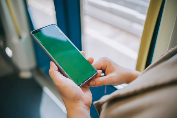 istock close up asian chinese woman using phone reading text message sitting in train traveling to work with green screen chroma key 1390634607