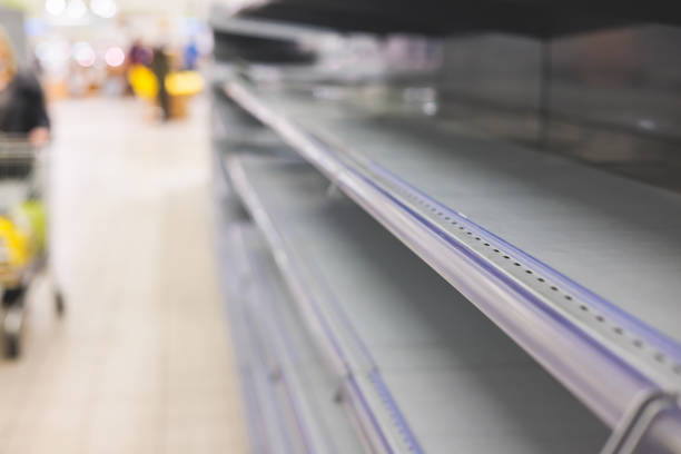 View of empty supermarket shelves, grocery store work stoppage closes, sanctions and embargo, panic buying with supplies and goods shortage, food crisis and deficit concept stock photo