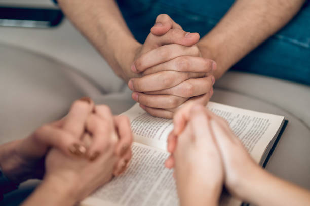 istock Close up picture of hands while praying 1390636705