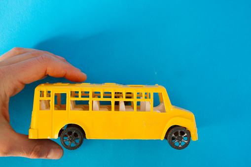 Yellow school bus toy with copy space
