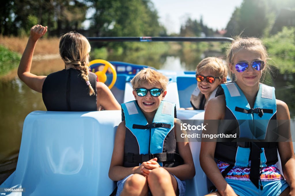 Family enjoying riding a pedalo on a river Family enjoying summer vacations vacations. Mother and kids riding a pedalo on river.
Nikon D850 Pedal Boat Stock Photo
