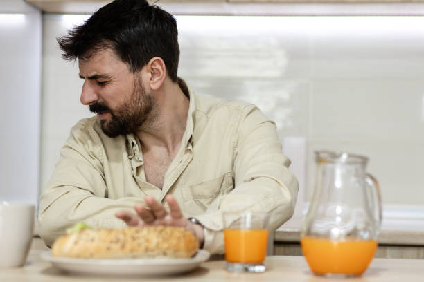istock Young man refusing to eat unhealthy food 1390641333