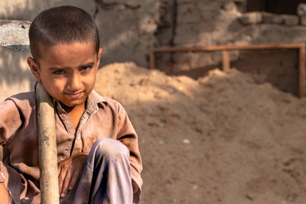 istock child boy working with the shovel on a construction site 1390641574