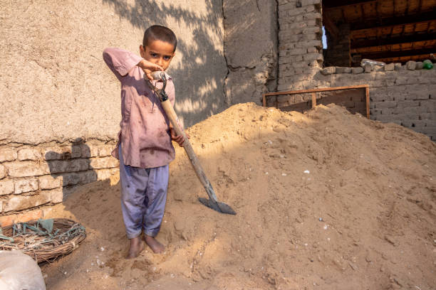 istock child boy working with the shovel on a construction site 1390641620